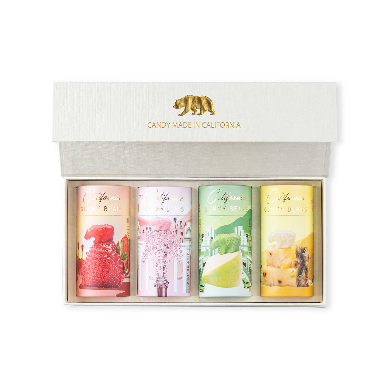 A set of four California Gourmet Gift Canisters in a white box with gold accents and a golden bear stamp, containing sour strawberry, rosé, apple, and pineapple.