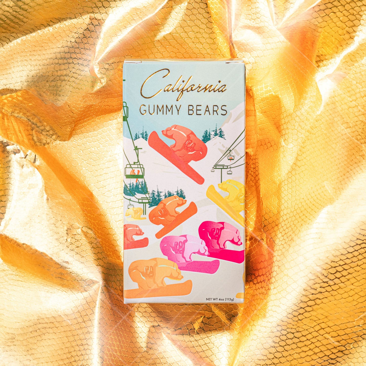 A box of California Gummy Bears on a yellow background with a festive design featuring gummy bears on snowboards.