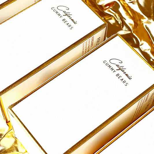 Limited edition gold foil gift boxes of Luxury California Gummy Bears with various flavors including Raspberry, Strawberry, Pink Grapefruit, Tangerine, Mango & Peach.
