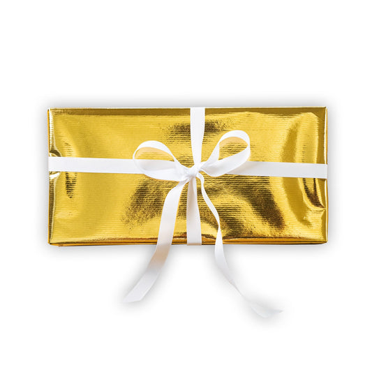 Gold gift wrap with a white ribbon on a white background